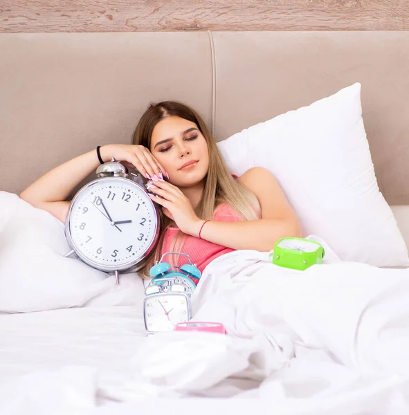 Young woman waking up in the morning in bed — Stock Photo, Image