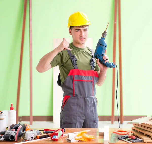Young man carpenter working in workshop — Stock Photo, Image