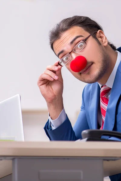Funny employee clown working in the office — Stock Photo, Image