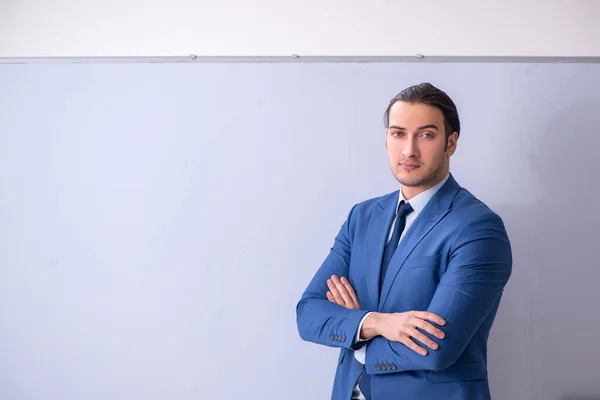 Young man employee in business presentation concept — Stock Photo, Image