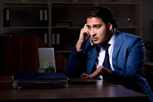 Young male employee working night in the office — Stock Photo, Image