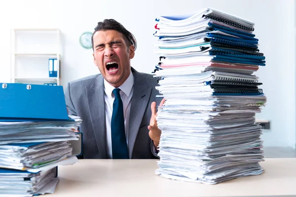 Businessman with heavy paperwork workload