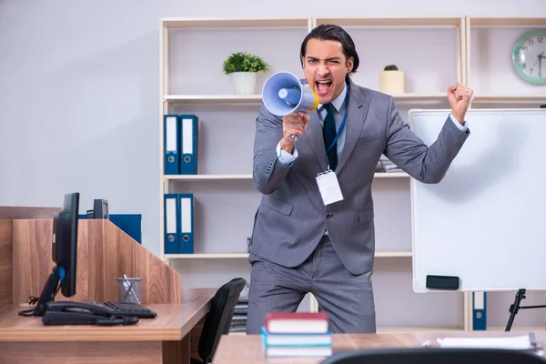 Young businessman standing in front of white board — Stock Photo, Image