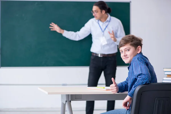 Young male teacher and boy in the classroom — Stock Photo, Image