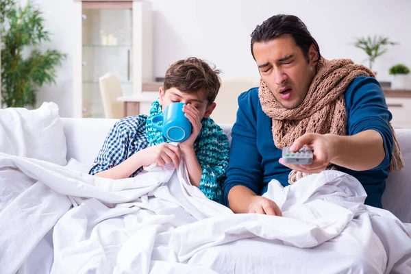 Young father caring for sick son