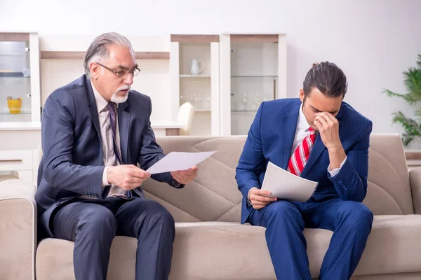 Two businessman discussing business in office