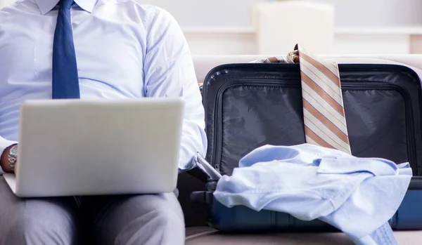 Businessman preparing packing for business trip — Stock Photo, Image