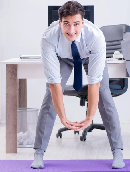 Businessman doing sports in office during break — Stock Photo, Image