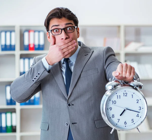 Businessman with alarm clock in the office — Stock Photo, Image