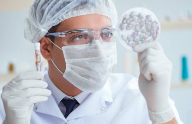 Laboratuvarda parfüm karıştıran bir kimyager.