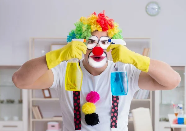 Забавный клоун делает уборку дома — стоковое фото