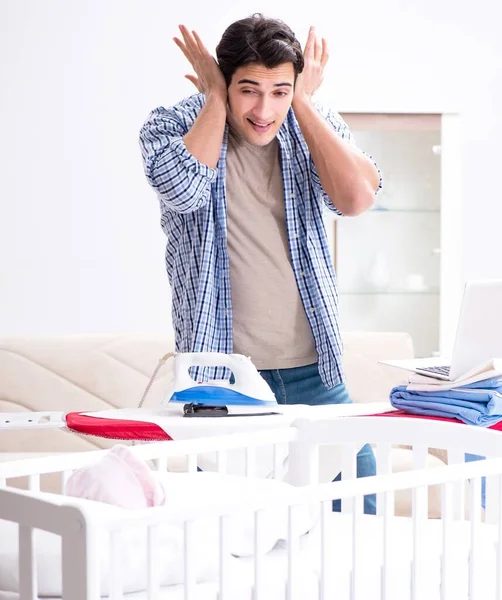 Young dad looking after newborn baby