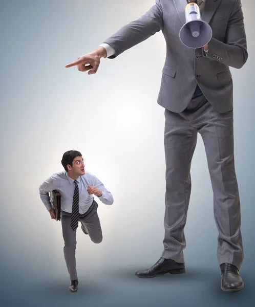 Bad angry boss shouting at employee with loudspeaker — Stock Photo, Image