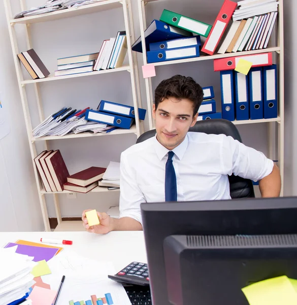 Empresario trabajando en la oficina con montones de libros y papeles — Foto de Stock