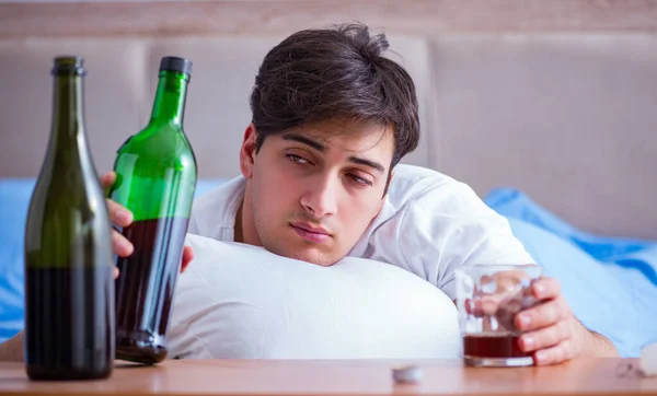 Alkoholisierter Mann im Bett löst Depression aus — Stockfoto