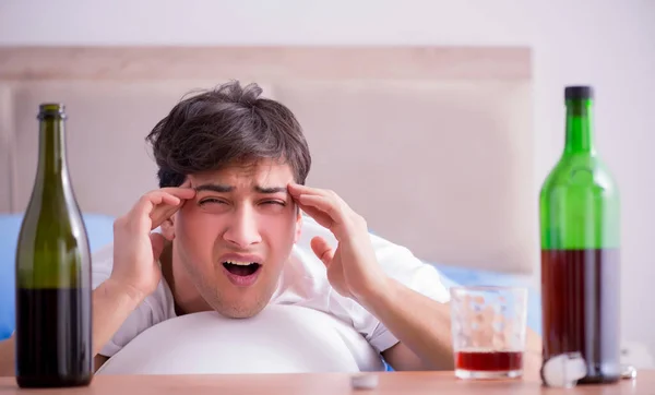 Man alkoholhaltiga drycker i sängen går igenom bryta upp depression — Stockfoto