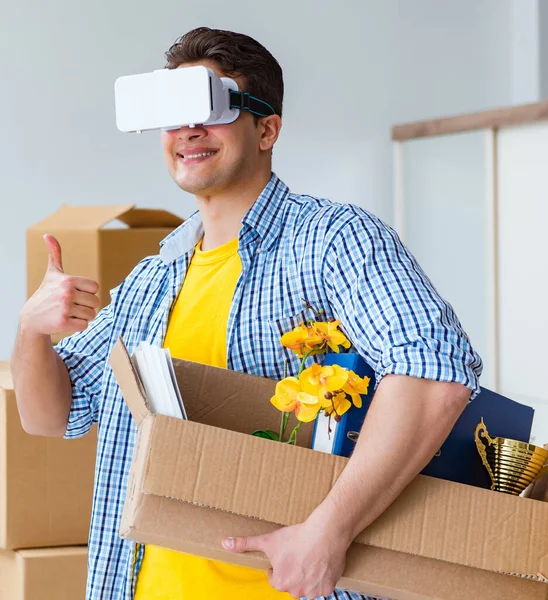 Young man wearing VR glasses moving in new apartment — Stock Photo, Image