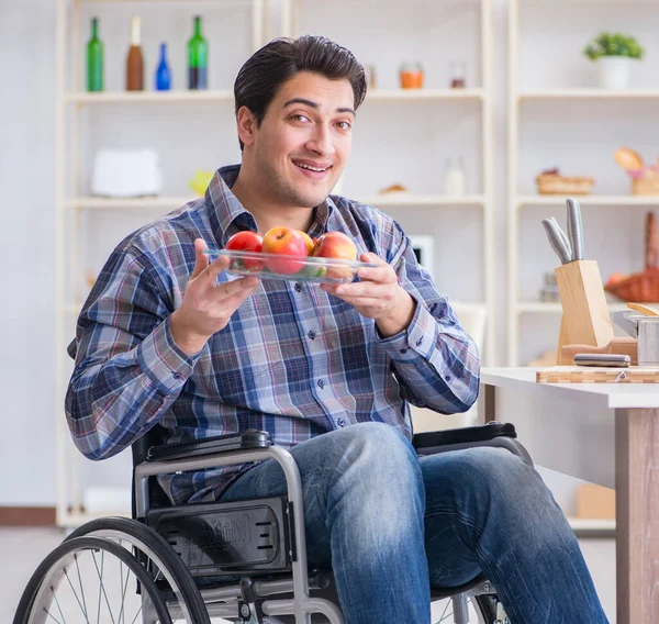 Young disabled husband preparing food salad
