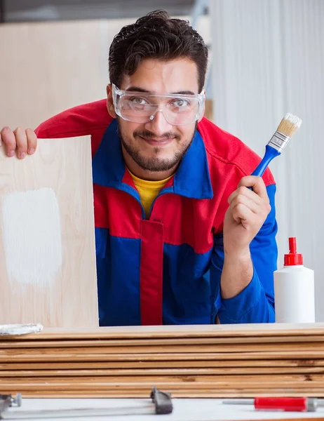 Yooung repairman carpenter working with paint painting — Stock Photo, Image