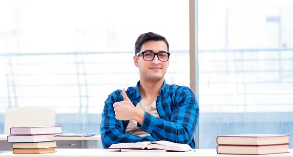 Student studying in the empty library with book preparing for ex — Stock Photo, Image