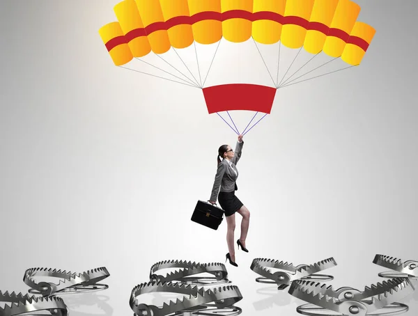 Businesswoman falling into trap on parachute — Stock Photo, Image