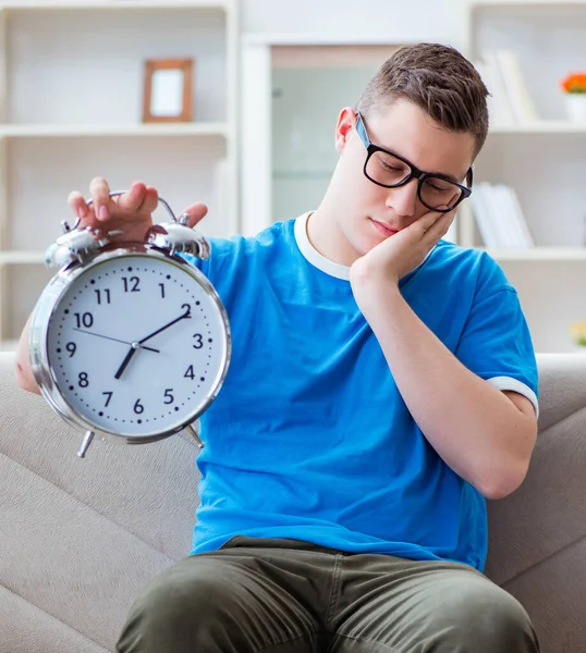 Sınavlara hazırlanan genç öğrenci kanepede ders çalışıyor.