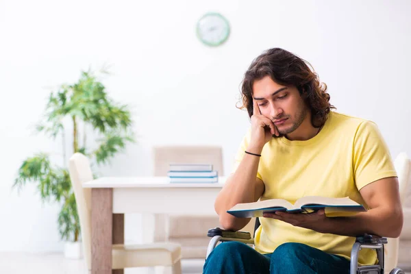 Male disabled student preparing for exams at home