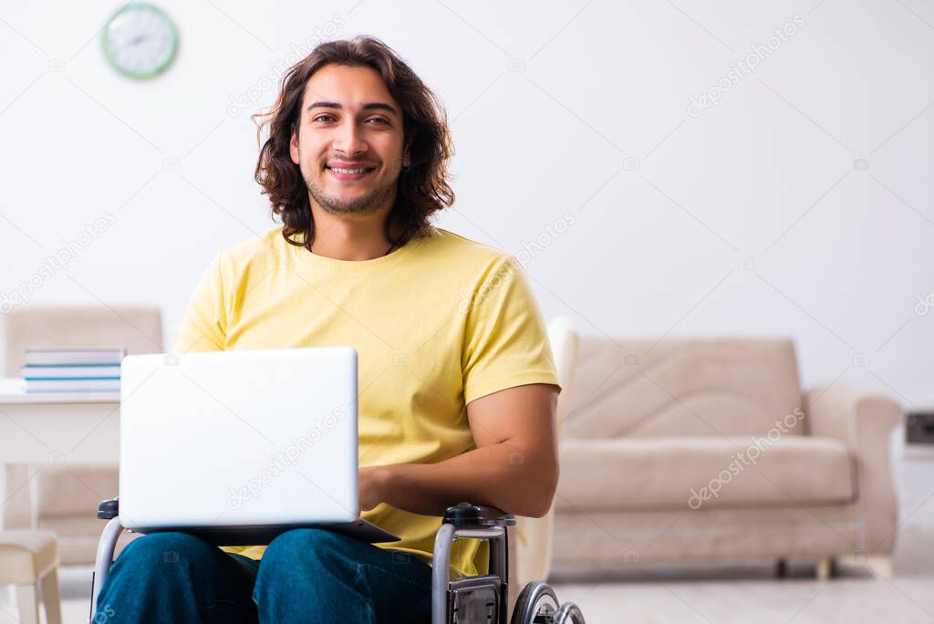 Male disabled student preparing for exams at home