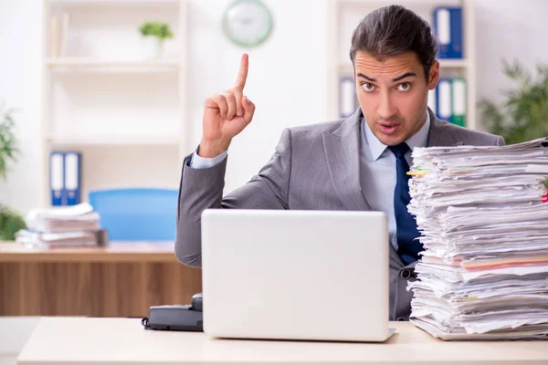 Young male businessman unhappy with excessive work — Stock Photo, Image