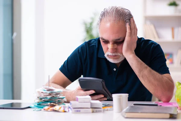 Vieil homme blessé dans le concept de planification budgétaire — Photo