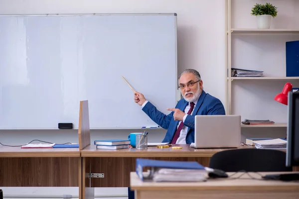 Old male boss employee working in the office