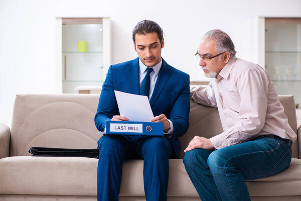 Young male lawyer visiting old man in testament concept