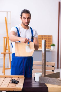 Genç erkek müteahhit atölyede çalışıyor.