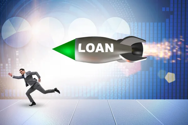 Concept of loan and debt with businessman chased by rocket — Stock Photo, Image