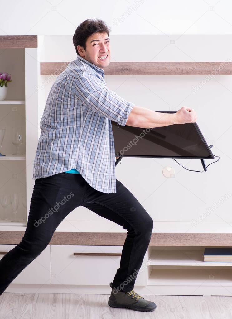 Man trying to fix broken tv