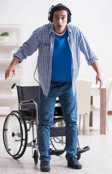 Disabled man listening to music in wheelchair — Stock Photo, Image