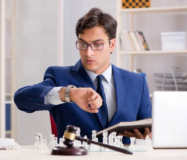 Young lawyer playing chess to train his court strategy and tacti