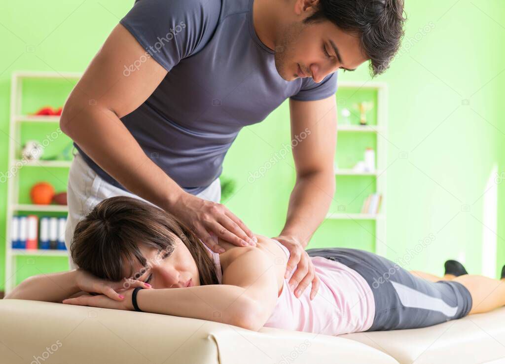 Young doctor chiropractor massaging patient