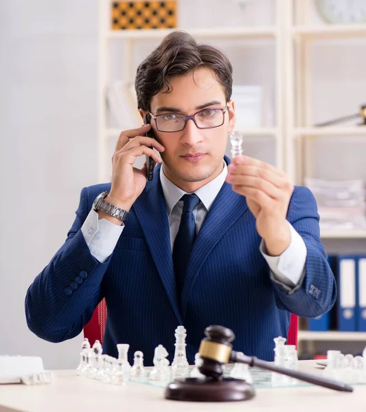 Young lawyer playing chess to train his court strategy and tacti