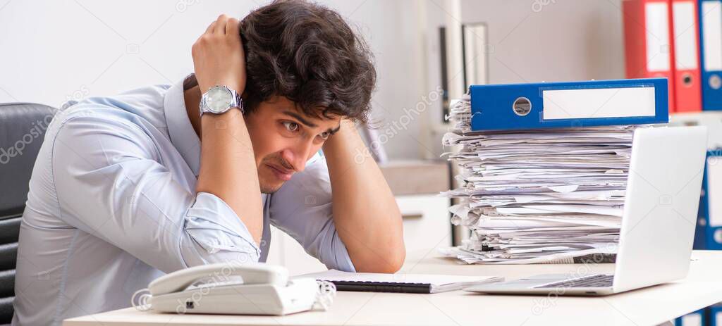 Overloaded busy employee with too much work and paperwork