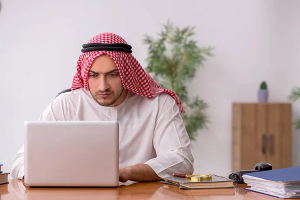 Young male arab employee working in the office