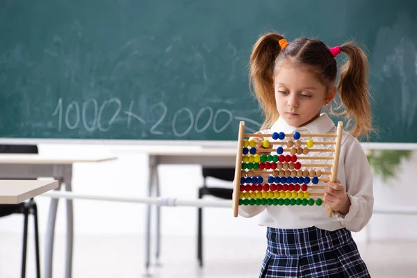 Small girl in front of blackboard in the classroom — Stock Photo, Image
