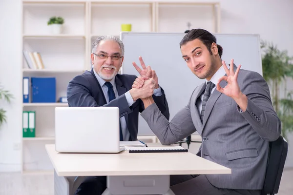 Old and young businessmen in business meeting concept