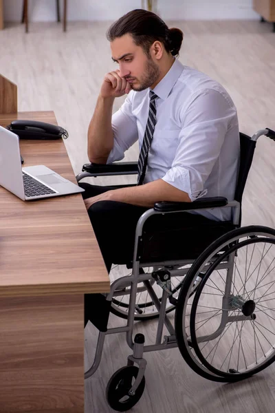 Young disabled employee suffering at workplace