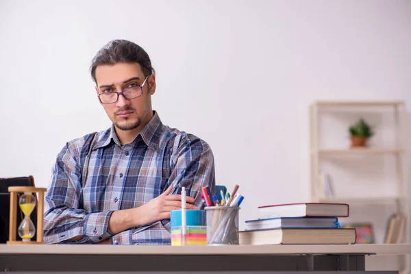 Young male student sitting in the classroom — Stock Photo, Image