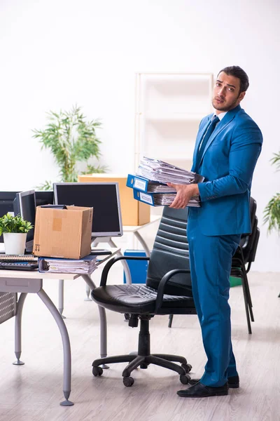 Young male employee in moving concept