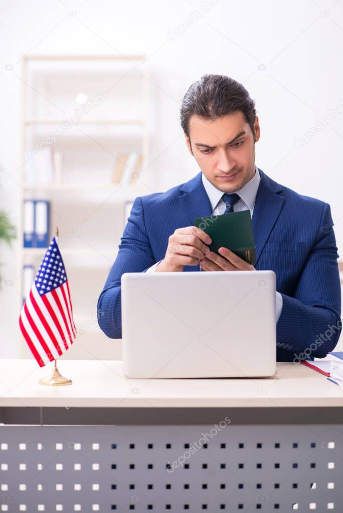 Young man checking passport at USA embassy
