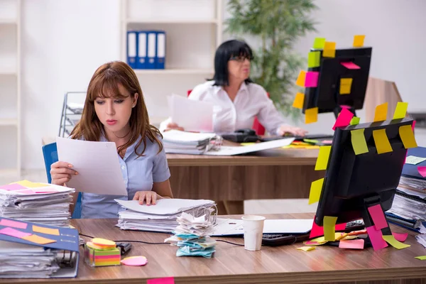 Two female employees and excessive work in the office — Stock Photo, Image