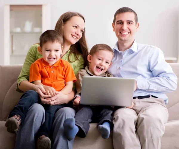 Young family surfing internet and looking at photos — Stock Photo, Image