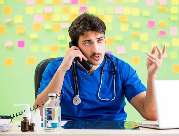 Young doctor with many reminders and urgent work — Stock Photo, Image